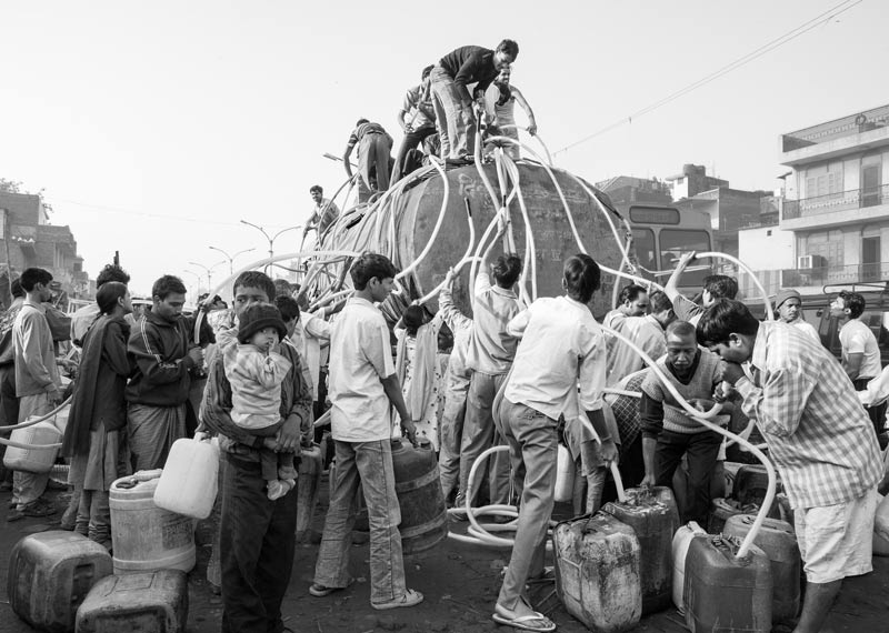 Human Right to Water in Delhi - Hurrying up to the top of the tanker to secure a share in the water in an unauthorized colony in Delhi